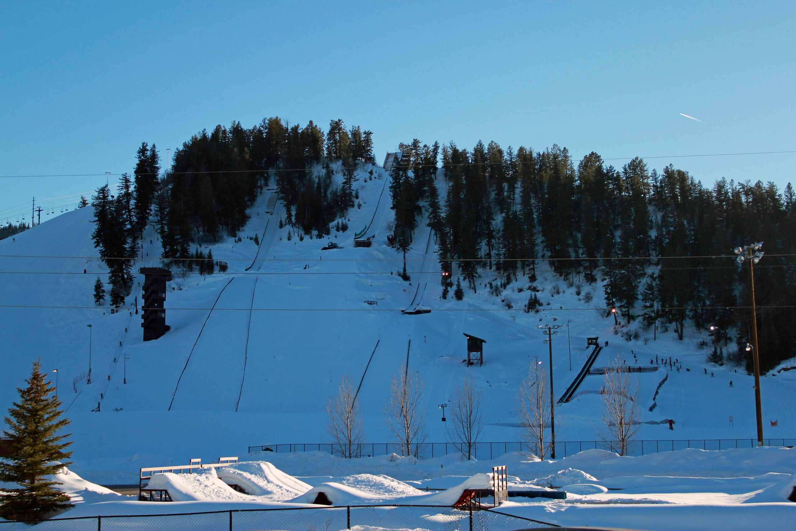 Snow-covered Howelsen Hill ski slopes and ski jumps at dusk in Steamboat Springs, Colorado